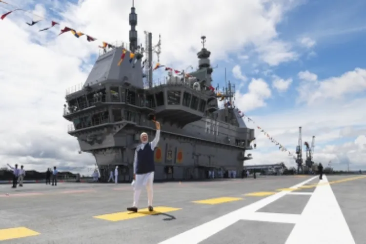 Prime Minister Narendra Modi waves after commissioning India's first indigenous aircraft carrier