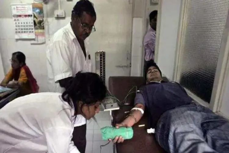 Rafat Khan donating blood in district hospital