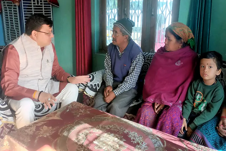 Uttarakhand Chief Minister Pushkar Singh Dhami with the family of Pushkar Singh Airi at Tanakpur in Champawat district. Airi is one of the 41 workers trapped in the Silkyara Tunnel.