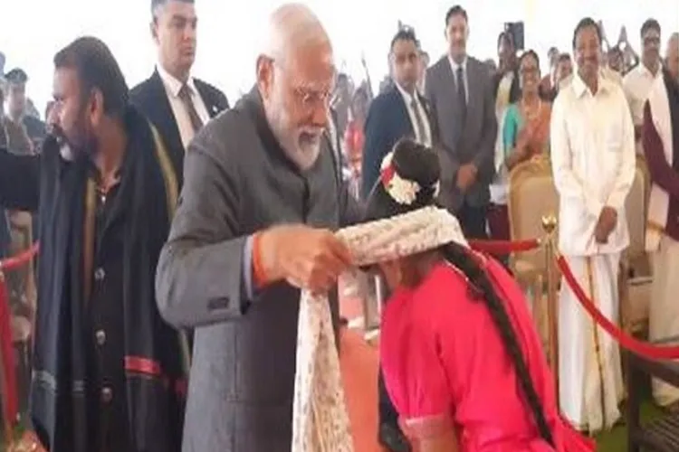 Prime Minister Narendra Modi gifting his shawl to a girl during Pongal celebrations