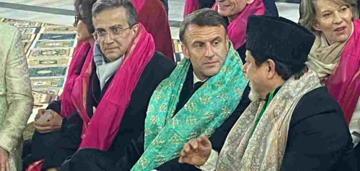 French President Emmanuel Macron listening to head of Hazrat Nizamuddin shrine management