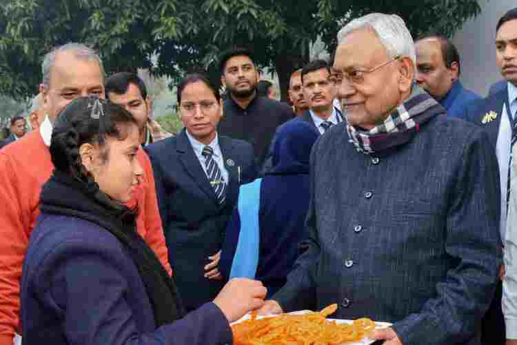 Nitish Kumar with a school girl before resigning from the post of CM