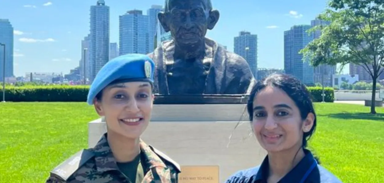 Major Radhika Sen (in uiniform) standing in front of Mahatma Gandhi's statue in the UN premises at Geneva, Switzerland