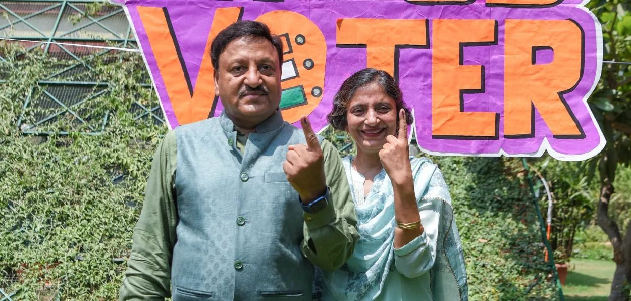 Indian Chief Election Commissioner Rajiv Kumar and his wife after casting their votes in Lok Sabha elections in New Delhi