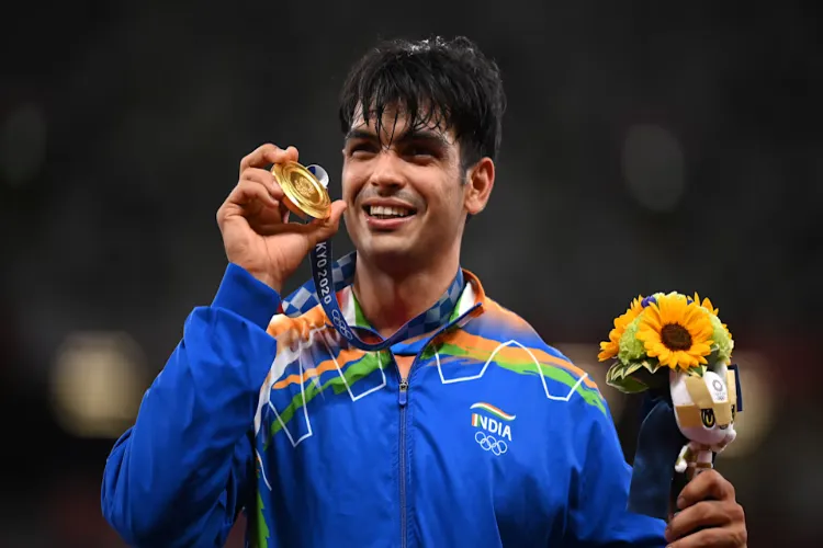 Neeraj Chopra holding Olympic gold medal in Tokyo