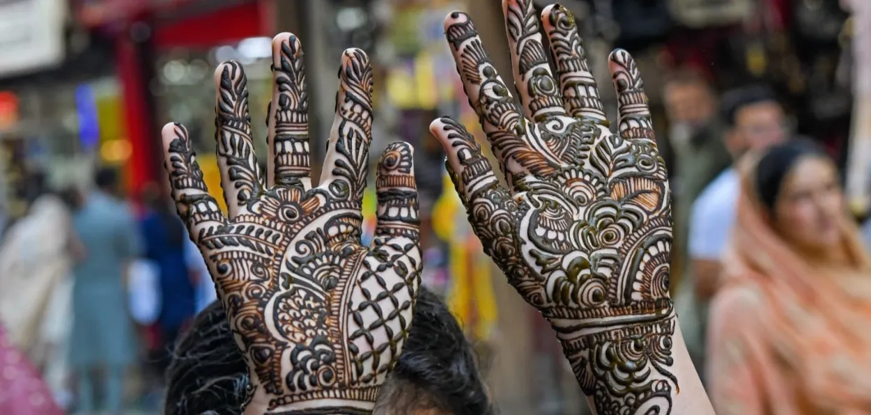 A woman displaying her hena-dyed hands in Srinagar marketplace (Pics by Basit Zargar)
