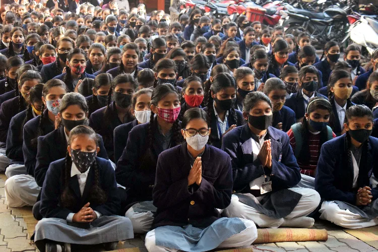 Children praying in assembly in a school in Uttar Pradesh