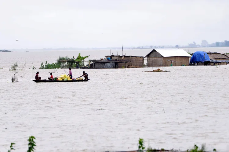 Villagers relocate belongings by boat amid Assam floods.