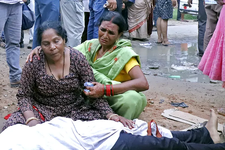 A woman crying over the body of her relative who died in the stampede during pilgrimage in hathras