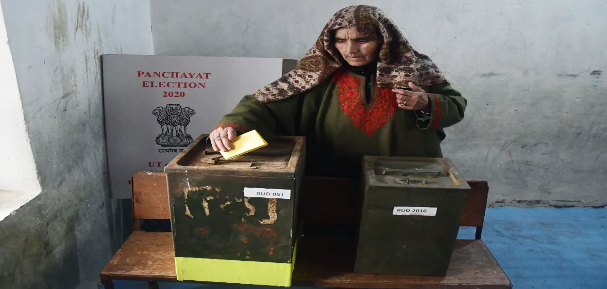 A Kashmiri woman casts her vote in the Panchayat elections chief of Jamaat-e-Islami, Jammu and Kashmir