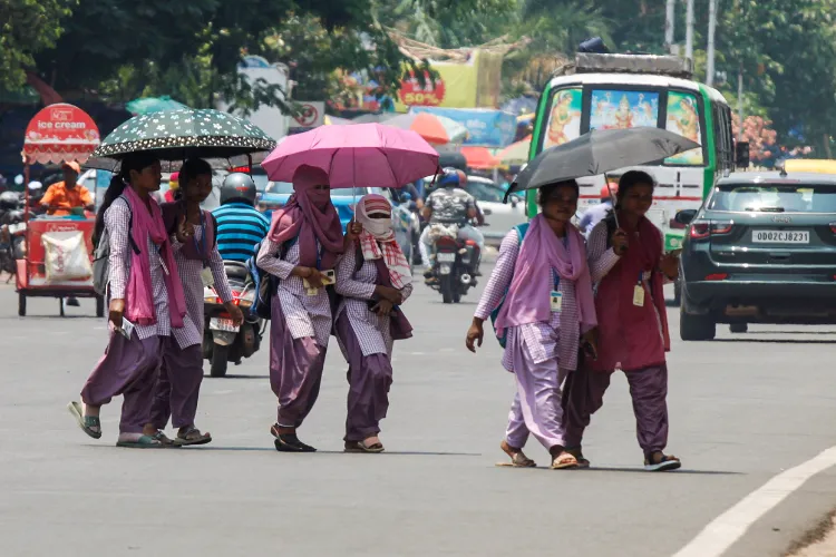 Women covering their faces and using umbrella to beat the heat in Bhubaneshwar, Odisha