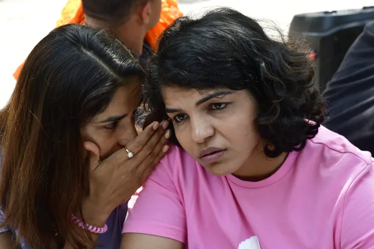 Sakshi Malik being whispered to by someone