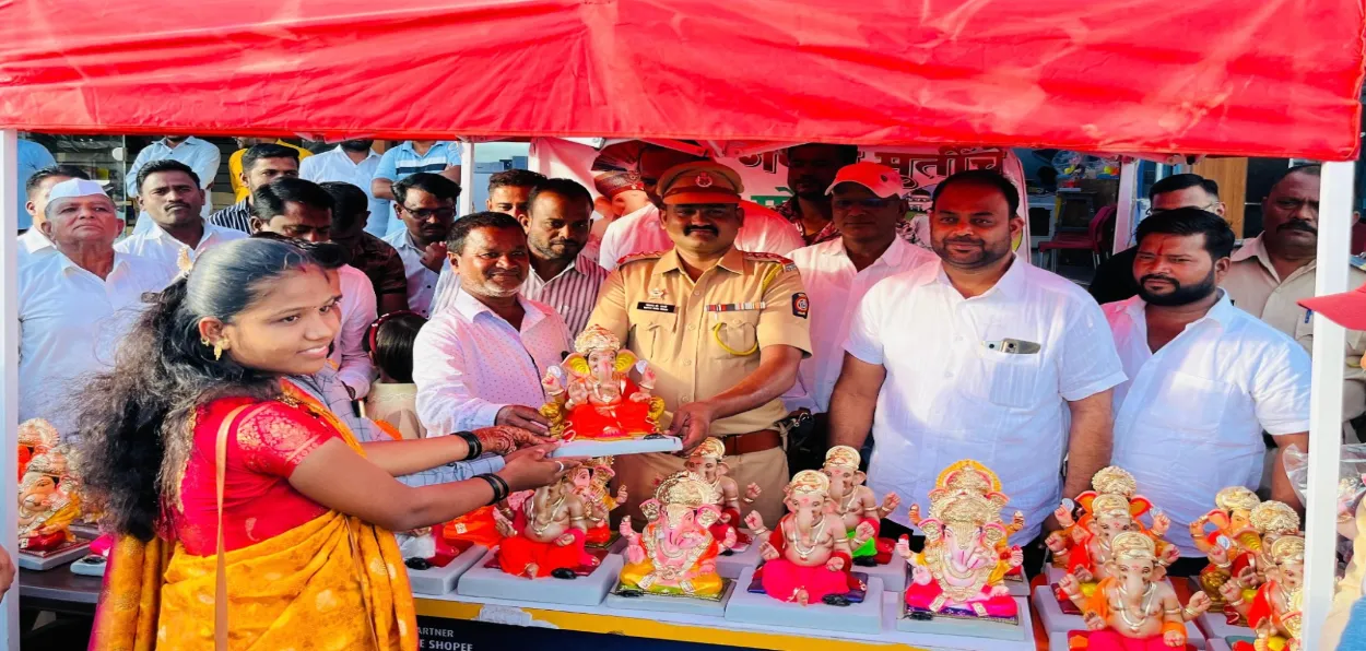 A Hindu woman being handed over Ganesh Idol by Police chief