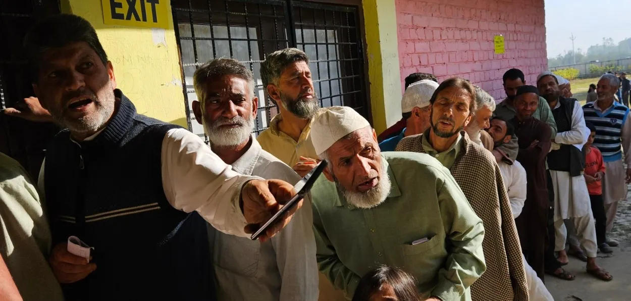 People stand in line to cast their vote in the first phase of J&K assembly elections