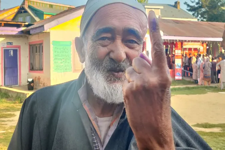 A resident of Jammu poses for camera after casting his vote