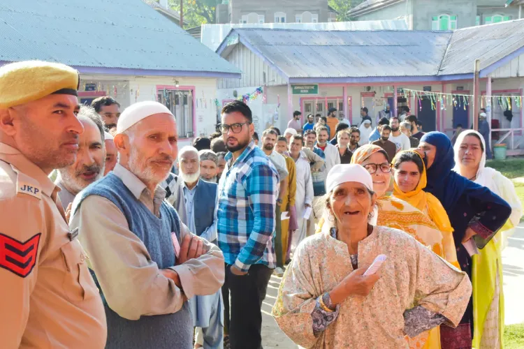 Voters stand in a queue to cast votes in Pulwama district 