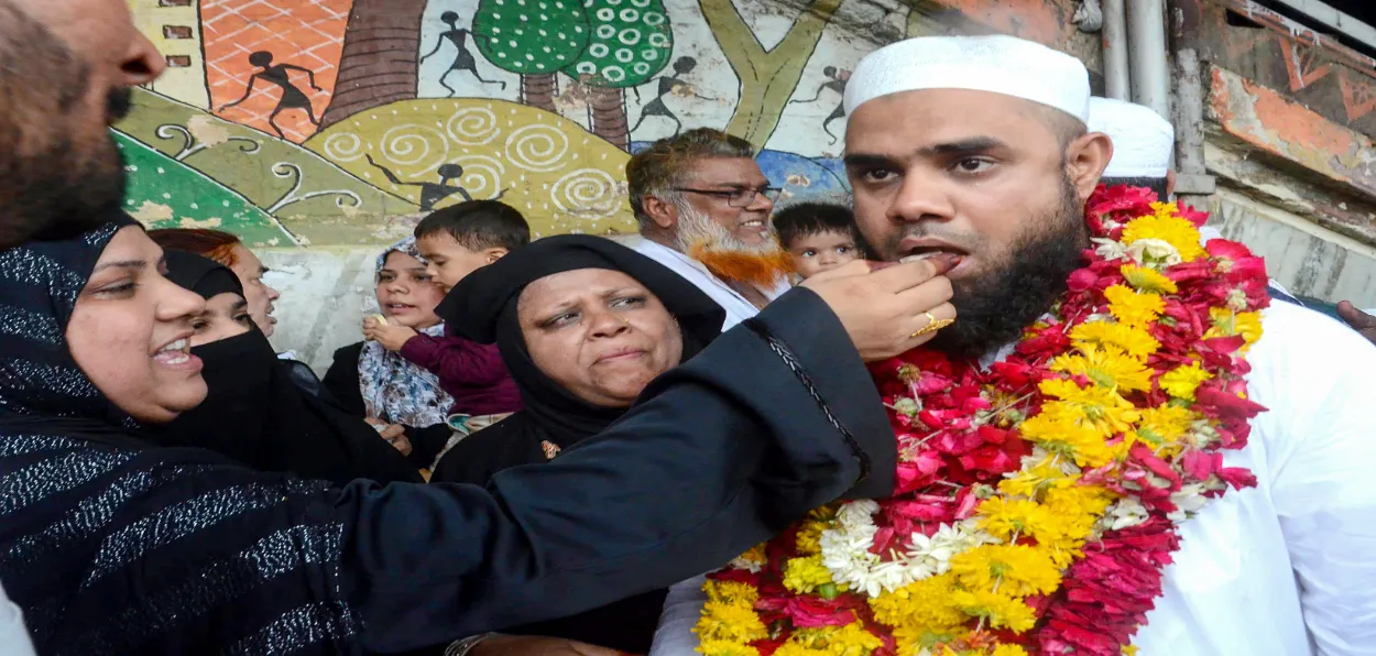 Family members welcome a man returning from Hajj Pilgrimage