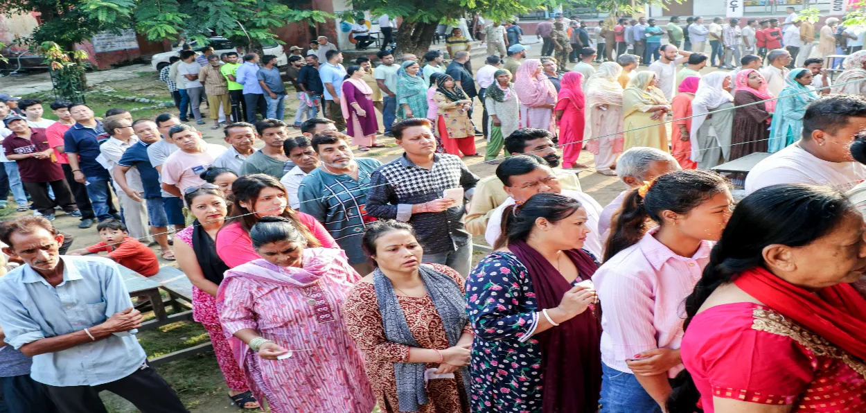 Women waiting in queue outside polling station in Jammu in the third and final phase of polling