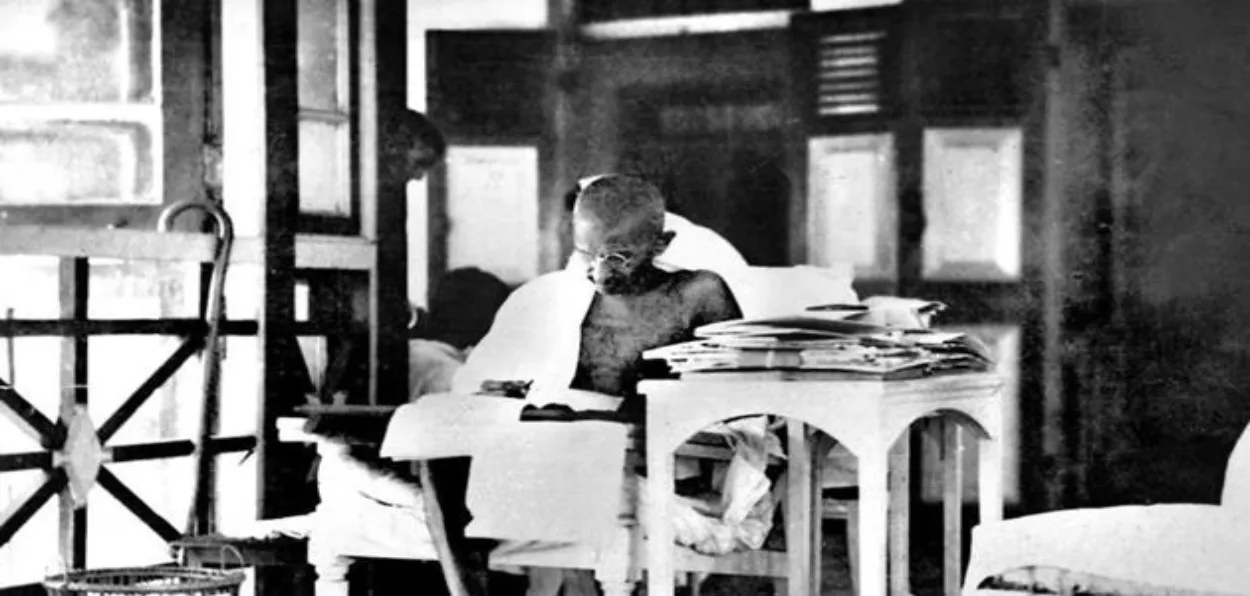 Mahatma Gandhi reading a newspaper