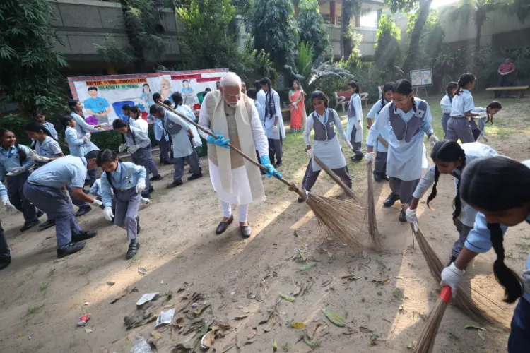 PM Narendra Modi with school children in a cleanlisness drive 