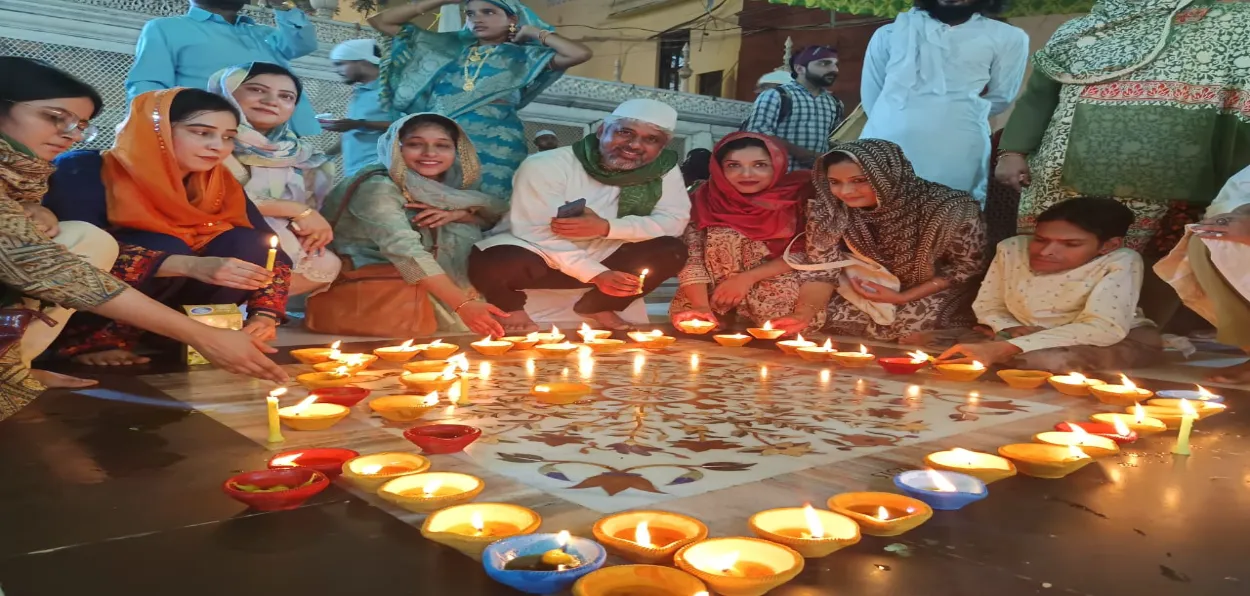 Hindus and Muslims lighting diyas and candle at the dargar of Hazrat Nizamuddin