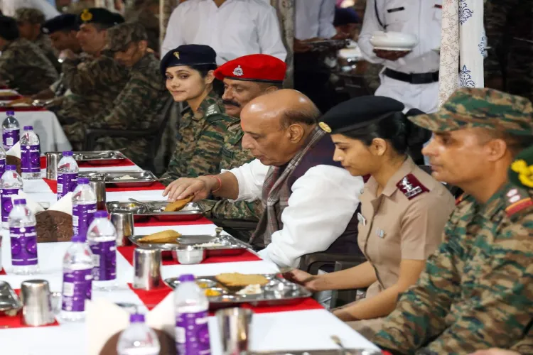 Defence Minister Rajnath Singh sharing a meal with troops at Tejpur (X)