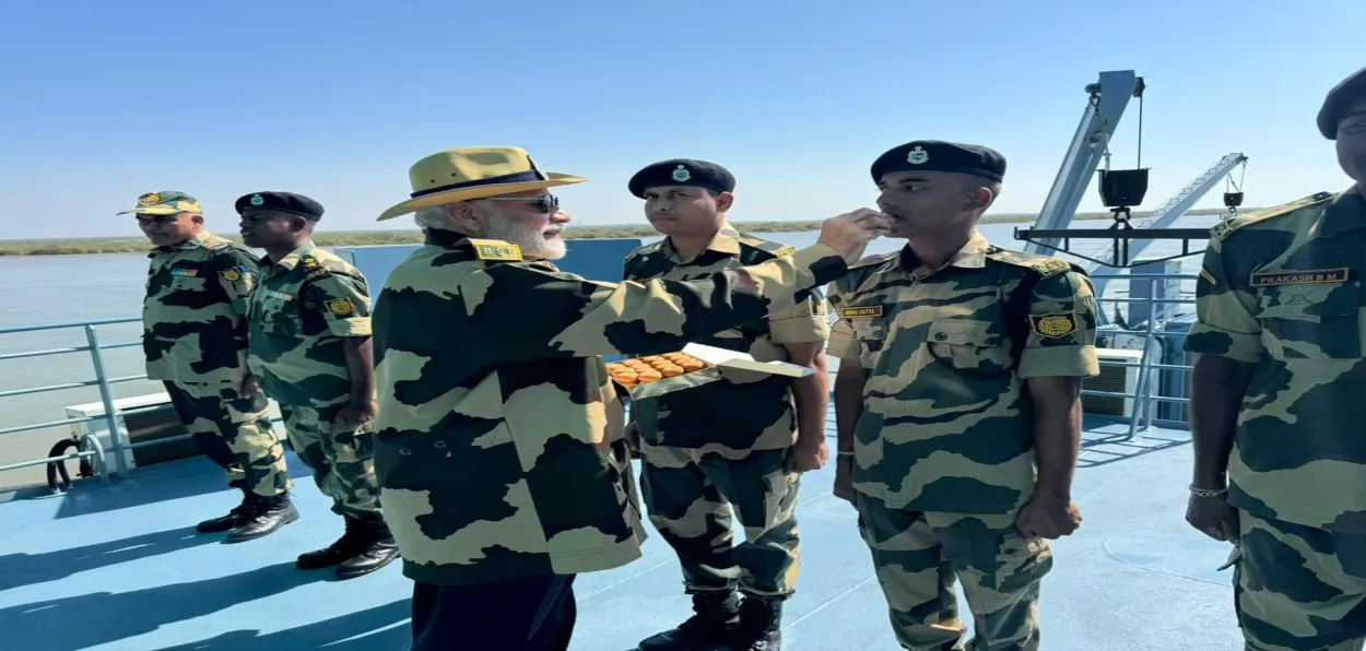 Prime Minister Narendra Modi feeds ladoo to a Jawan posted in Kutch, Gujarat