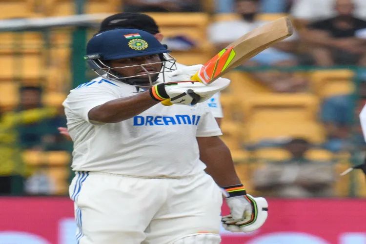 Sarfaraz Khan celebrates his half century during day three of the first cricket test match between India and New Zealand at Bengaluru on Friday 