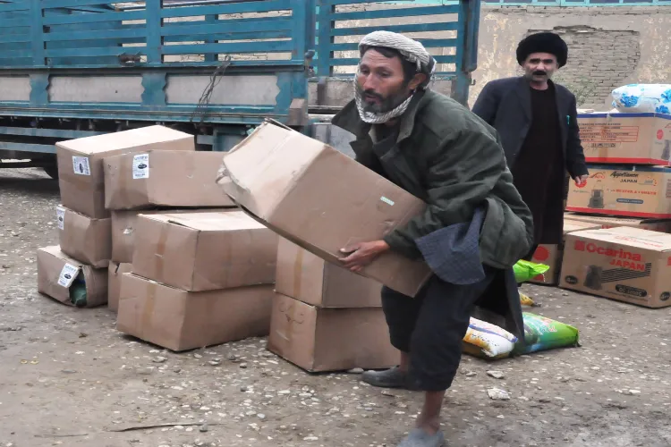 An Afghan man with relief distributed in Jawazjan province