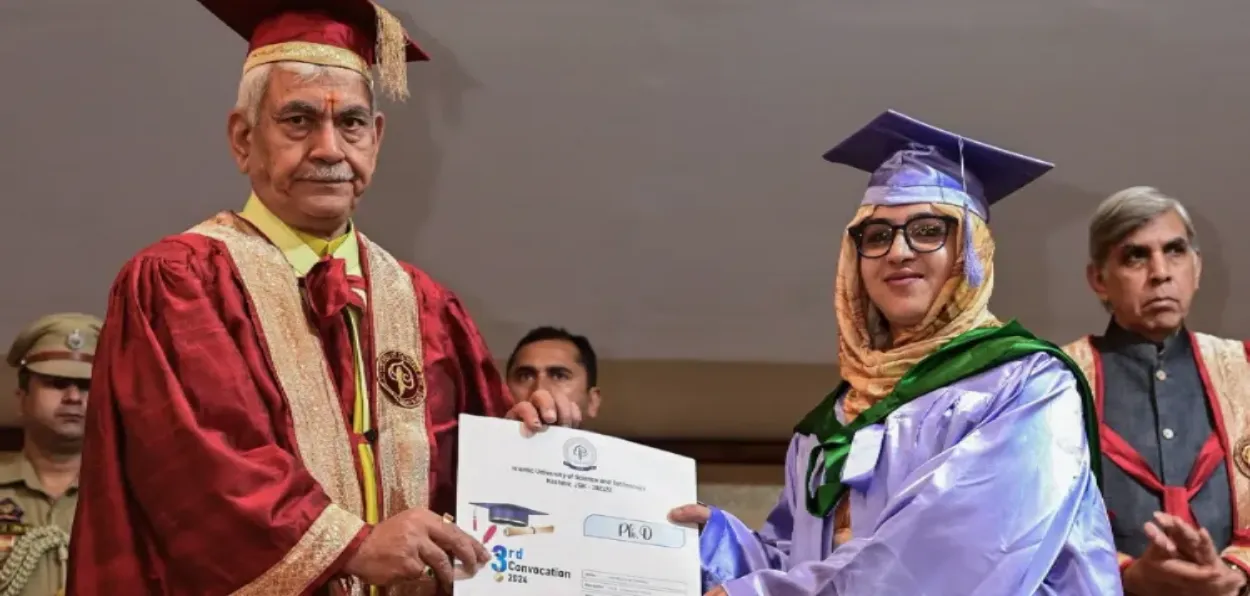 A Kashmiri woman from the University of Kashmir, Srinagar, receiving her degree from LG Manoj Sinha 