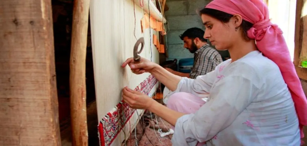 A Kashmiri woman weaving a carpet