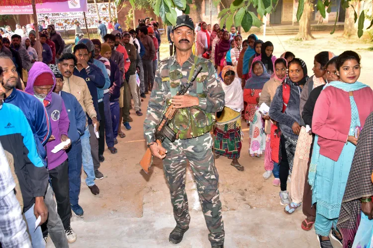 Ranchi: Voters line up at a polling booth to cast their vote under tight security