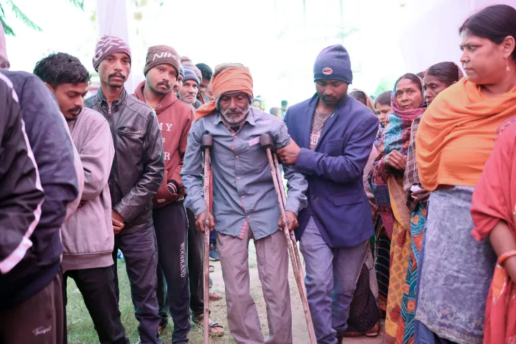 Ramgarh : Voters wait in a queue to cast their votes during the second and final phase of Jharkhand Assembly Elections