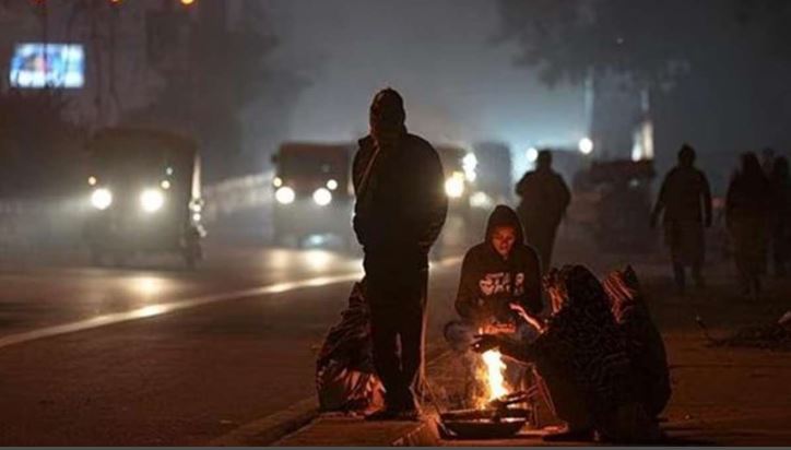 People warming up at a bonfire in Delhi