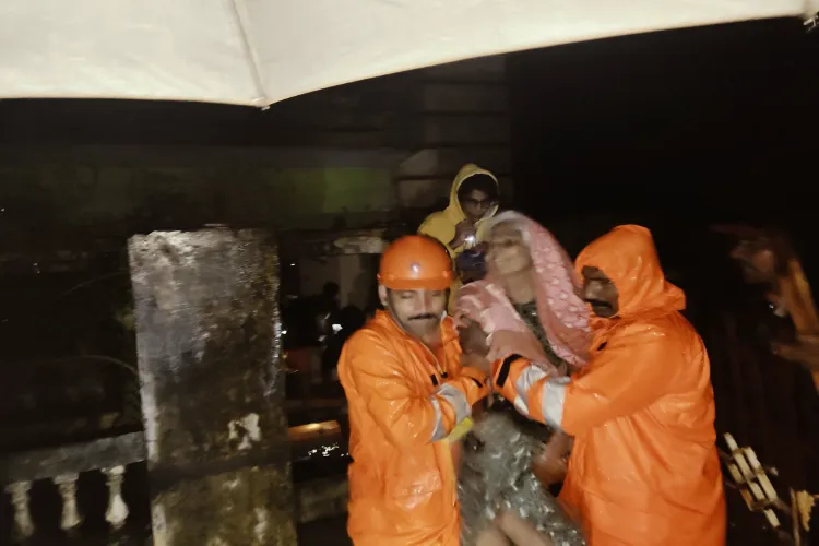 NDRF men rescuing a woman from as Puducheery area