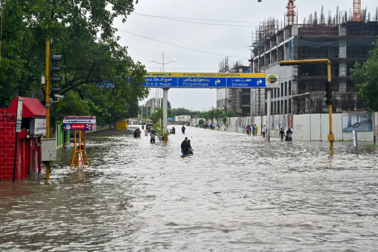 Chennai: Commuters wade through a waterlogged road amid rain