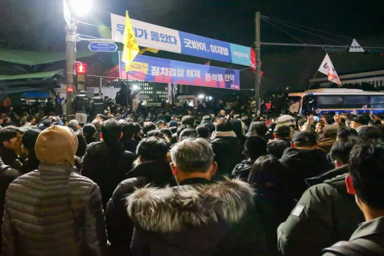 South Koreans cheering outside National Assembly in Seoul as martial law is withdrawn