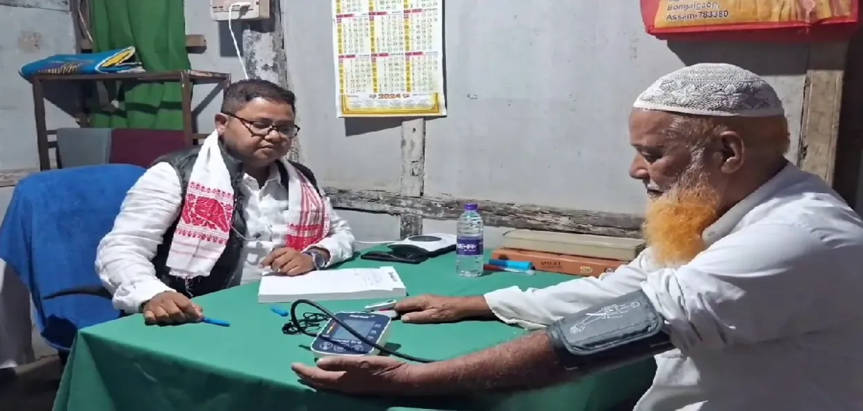 Dr. Rubul Ahmed with a patient at his no-fees clinic