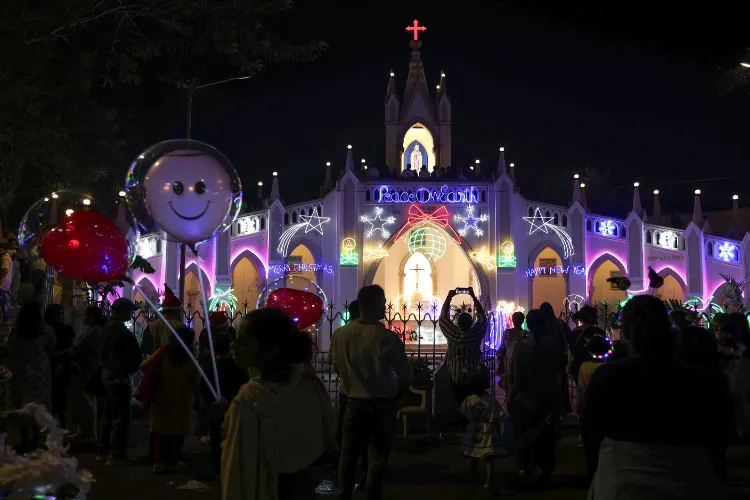 Devotees gather in front of Mount Mary Church on Christmas Eve, at Bandra in Mumbai on Tuesday