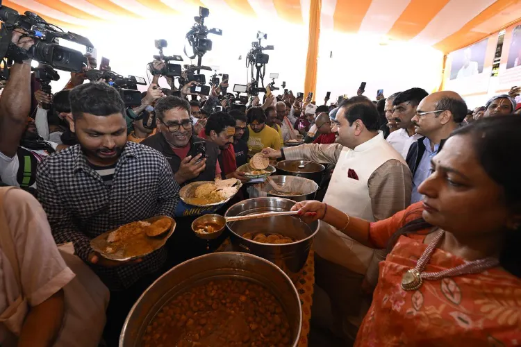 Indian tycoon Gautam Adani and his wife serving food to pilgrims at Mahakumbh (X)