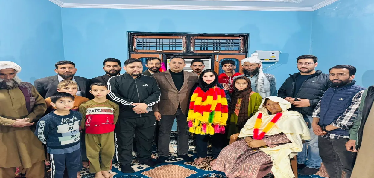 Heavily garlanded Nazia Bibi with her family and visitors at her home 