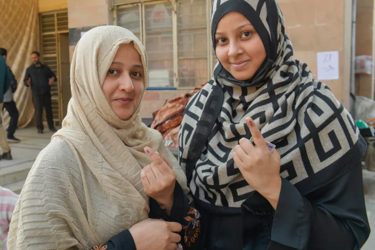 Women voters showing marks on their finger after casting their votes in Nizamuddin West, Delhi