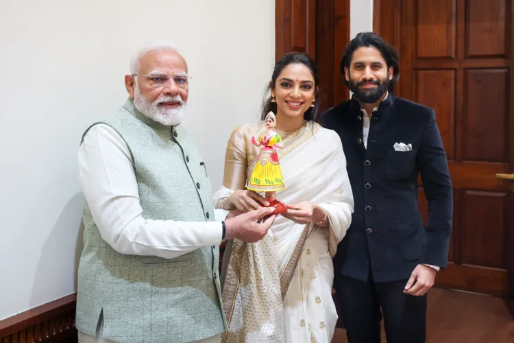 Sobhita Dulipala and husband Naga Chataniya presenting Prime Minister Narendra Modi a kondapalli bommala (doll)