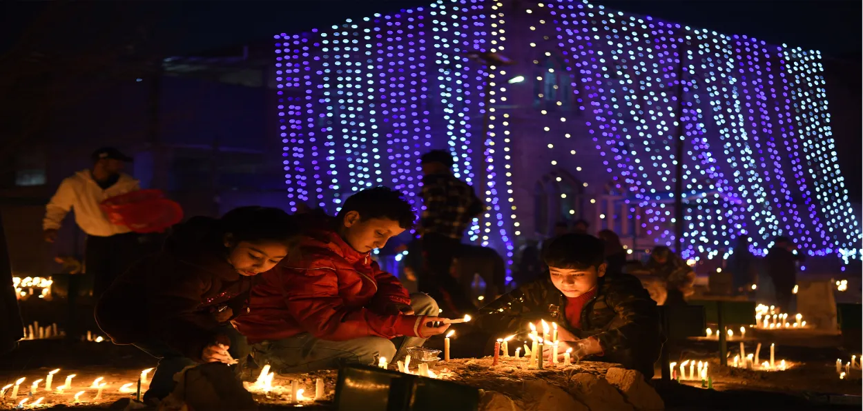 Children lighting candles at the graves in a srinagar cemetery on Shab-e-Barat (Basit zargar)