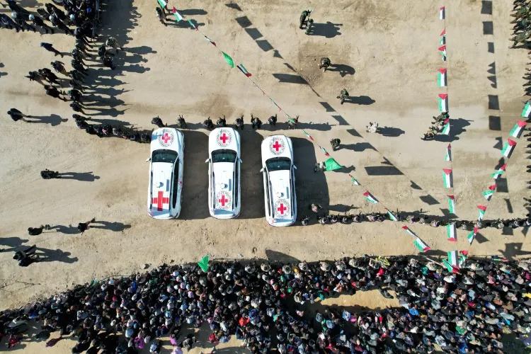 A drone view shows people gathering near Red Cross vehicles, on the day of the release of hostages held in Gaza 