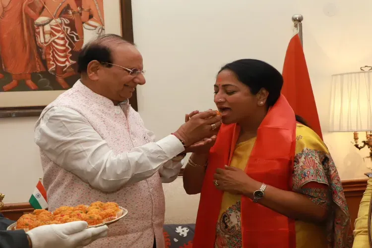 Delhi Lt Governor V.K. Saxena feeding ladoos to CM designate Rekha Gupta