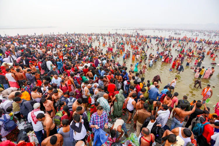 Devotees take a dip at Triveni Sangam during the ongoing Maha Kumbh 2025, in Prayagraj