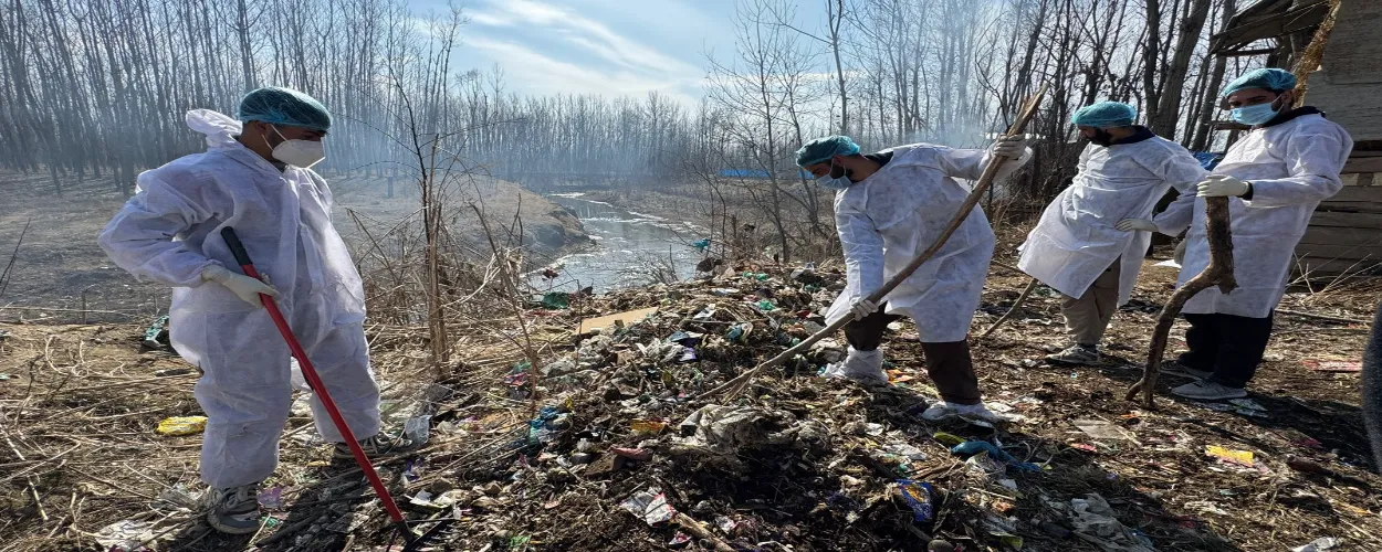 Javed Dar and youth of his village Muniwar  cleaning the garbage on the banks of river