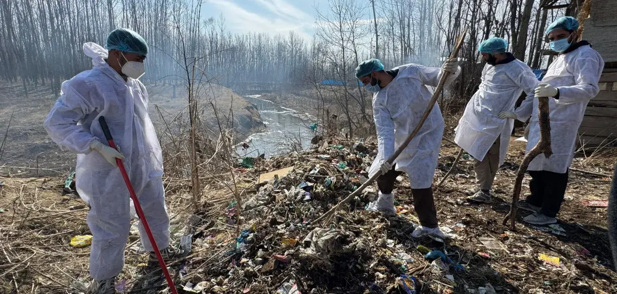 Javed Dar and youth of his village Muniwar  cleaning the garbage on the banks of river