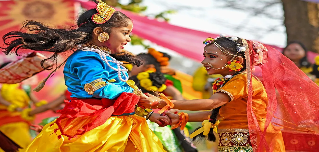 Children dressed as Radha and Krishna playing Holi in Mathura, Uttar Pradesh